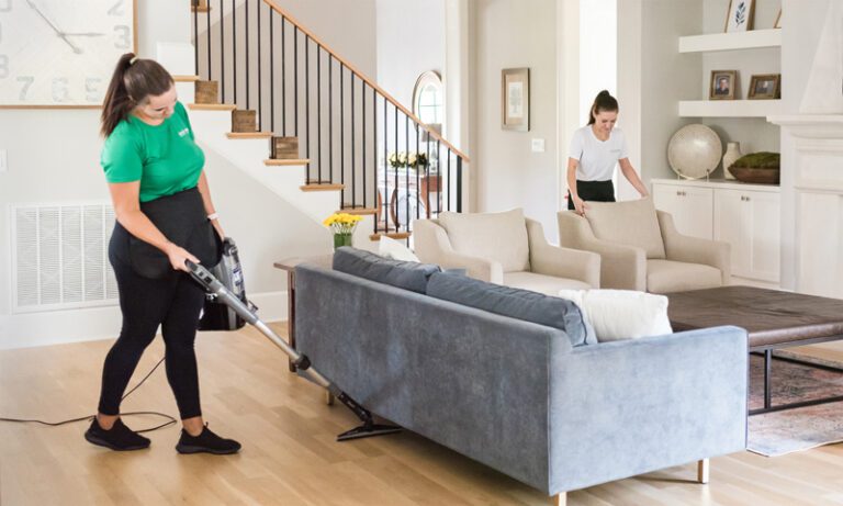 Simply Pure Home team members cleaning and vacuuming family room