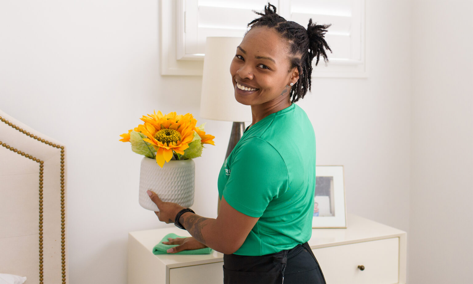 Simply Pure Home cleaner smiling while cleaning