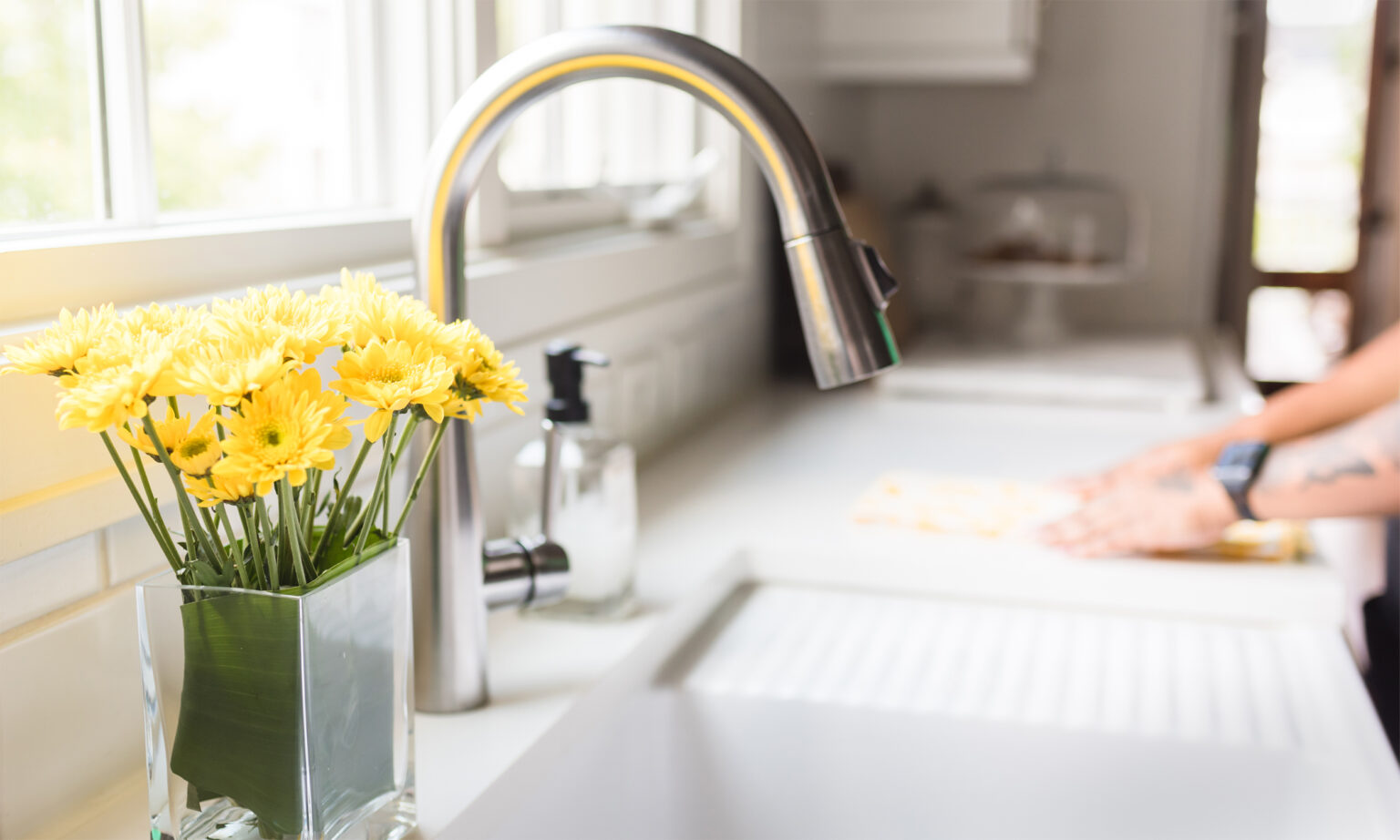 Clean kitchen sink with flowers